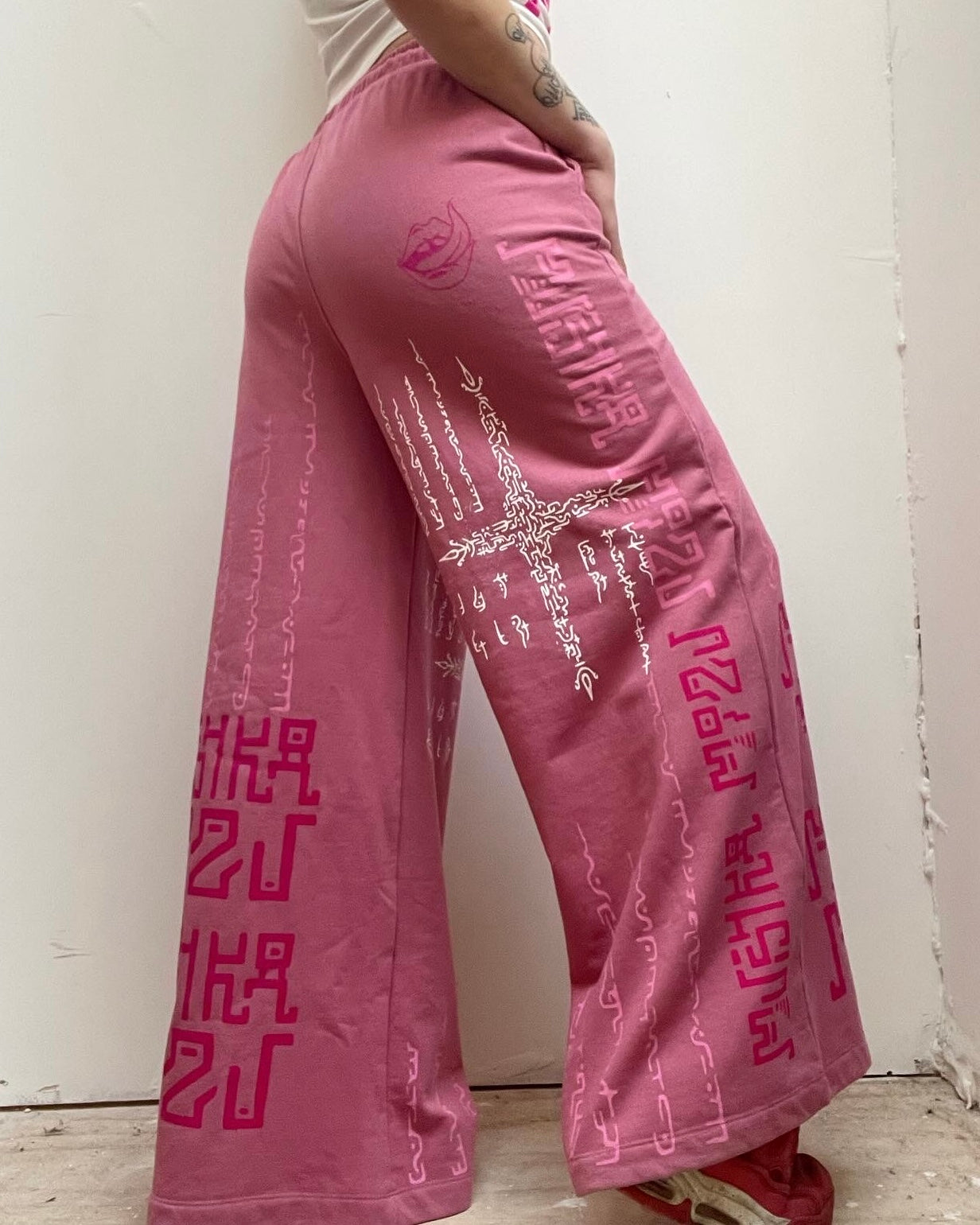 PINK MADNESS Alien Contact Hand printed wide leg tracksuit bottoms/ joggers. (Gender Neutral. Pink)