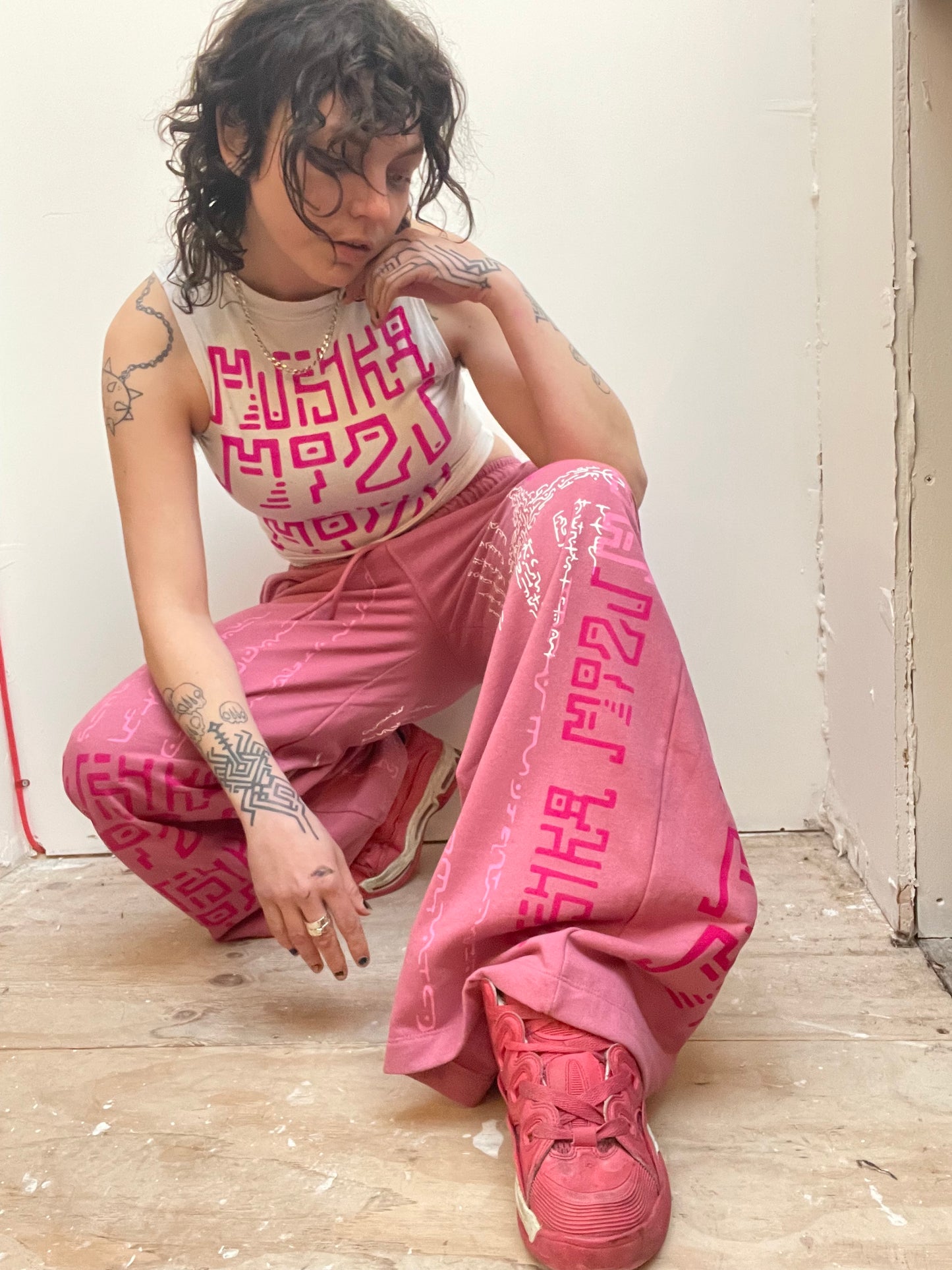 PINK MADNESS Alien Contact Hand printed wide leg tracksuit bottoms/ joggers. (Gender Neutral. Pink)