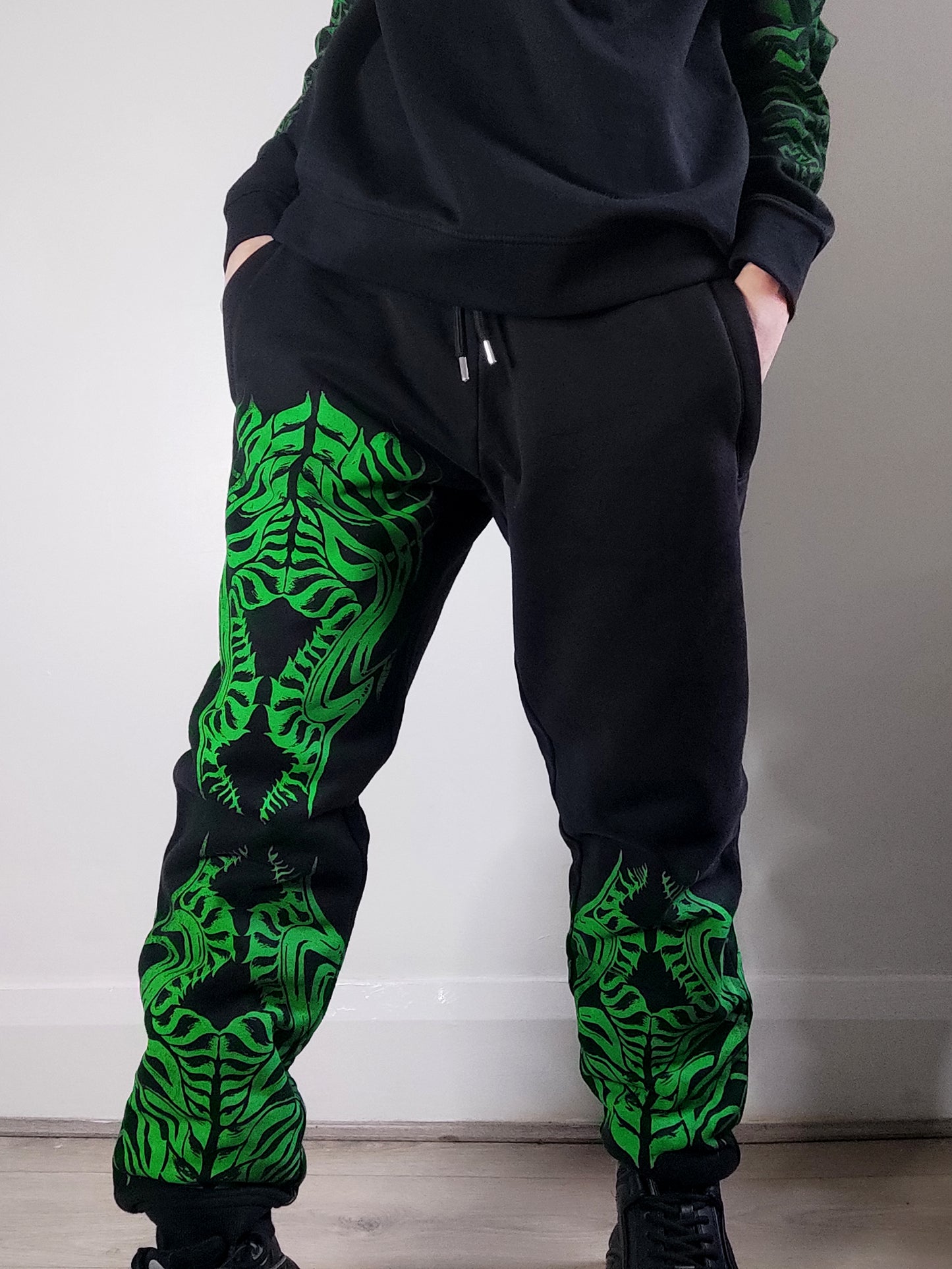 Biomechanika Hand printed gender neutral organic cotton tracksuit bottoms/Joggers. Black and Green